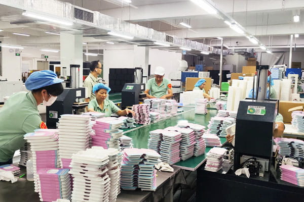 Packaging production in China - workers on the laminated box line
